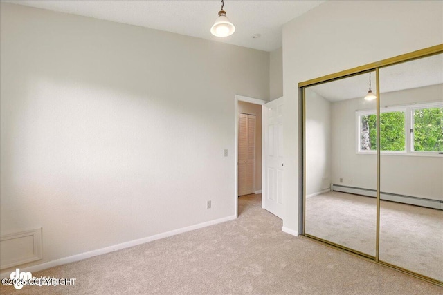 2631 Palmer Ct # C6, Anchorage, AK 99508 - unfurnished bedroom with carpet floors, a baseboard heating unit, a closet, and baseboards