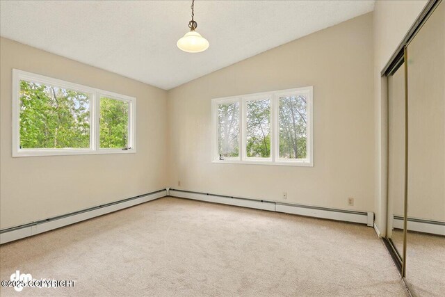2631 Palmer Ct # C6, Anchorage, AK 99508 - unfurnished bedroom with vaulted ceiling, carpet floors, a closet, and a baseboard heating unit
