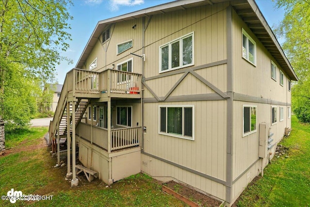 2631 Palmer Ct # C6, Anchorage, AK 99508 - rear view of property featuring a wooden deck and stairway