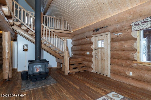 5920 Old Valdez Trl, Salcha, AK 99714 - entrance foyer featuring log walls, hardwood / wood-style floors, stairway, high vaulted ceiling, and a wood stove