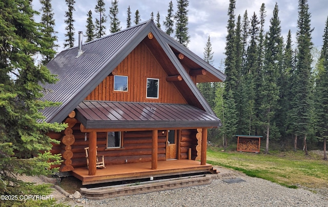 5920 Old Valdez Trl, Salcha, AK 99714 - view of front facade with a standing seam roof, a metal roof, log siding, and a view of trees