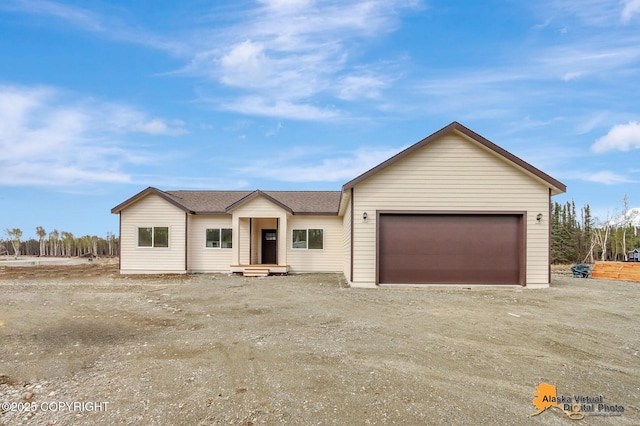 ranch-style home with an attached garage and driveway