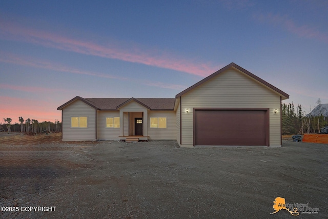 ranch-style house with an attached garage and dirt driveway
