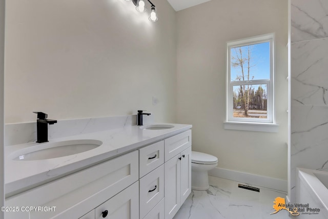 bathroom with double vanity, visible vents, a sink, and marble finish floor