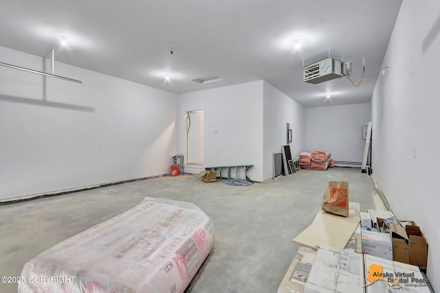 garage with a heating unit and a baseboard radiator