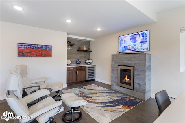 living area with recessed lighting, beverage cooler, and dark wood-type flooring