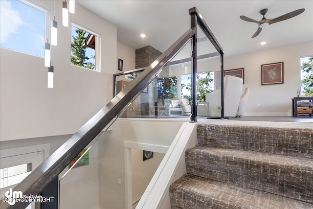 stairs with a ceiling fan, baseboards, and recessed lighting