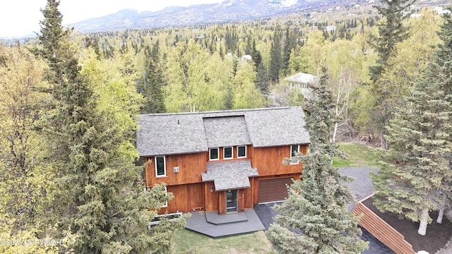 6816 Round Tree Dr, Anchorage, AK 99507 - view of subject property with a forest and mountains