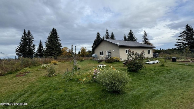 17225 Kimeluk St, Ninilchik, AK 99639 - view of side of home featuring a lawn and metal roof