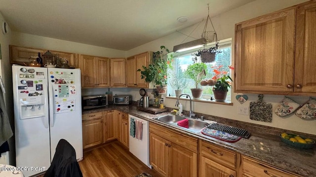 17225 Kimeluk St, Ninilchik, AK 99639 - kitchen with a toaster, dark countertops, white appliances, dark wood-type flooring, and a sink