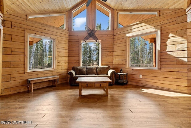 sitting room with wood ceiling, high vaulted ceiling, wood walls, and hardwood / wood-style floors