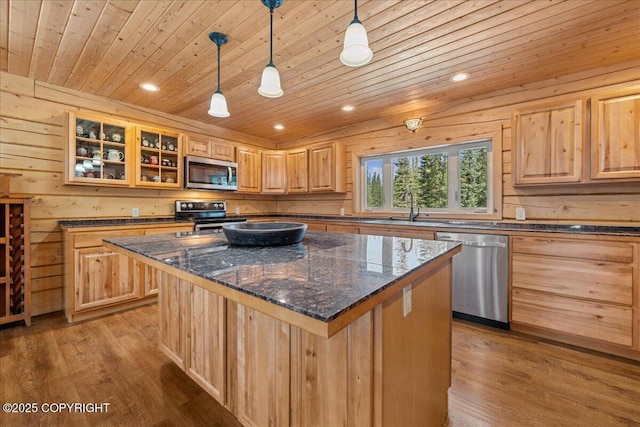 kitchen with wood finished floors, light brown cabinets, wood ceiling, a sink, and stainless steel appliances