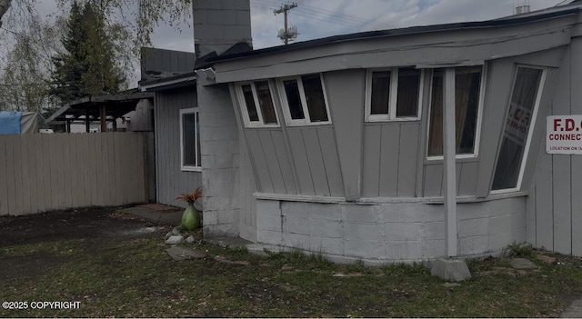 view of side of property featuring fence