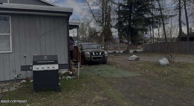 view of side of home featuring fence