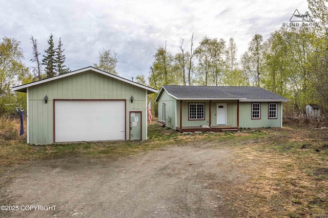 single story home with a garage and an outbuilding