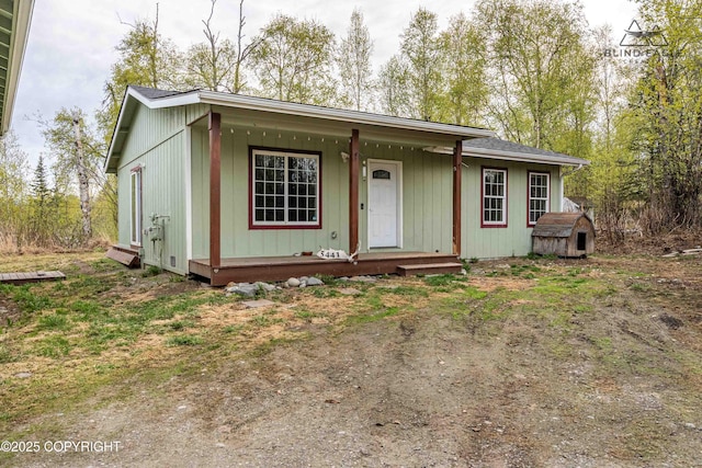 view of front facade with covered porch and an outbuilding