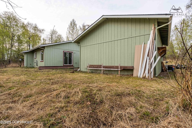 rear view of property featuring a lawn
