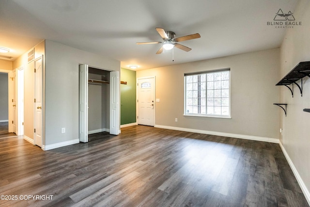 unfurnished living room featuring ceiling fan, dark wood finished floors, and baseboards