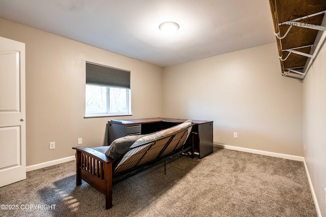 sitting room featuring carpet, baseboards, and a desk