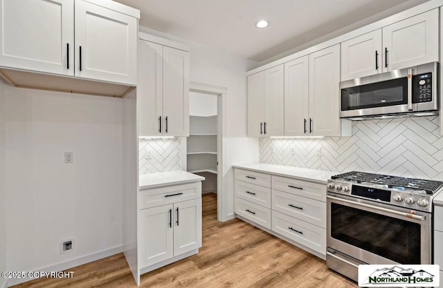 1205 N Williwaw Way, Wasilla, AK 99654 - kitchen with light countertops, stainless steel appliances, recessed lighting, white cabinetry, and backsplash