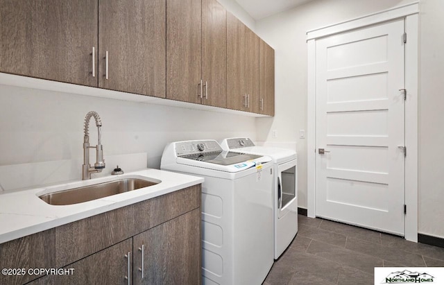 1205 N Williwaw Way, Wasilla, AK 99654 - clothes washing area featuring a sink, dark tile patterned flooring, washing machine and dryer, and cabinet space