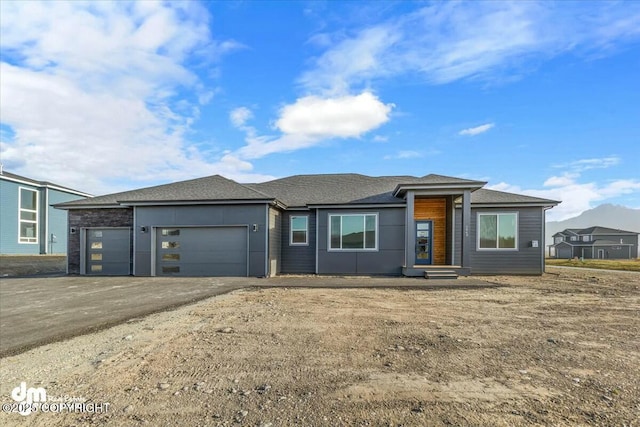 2600 S Sanctuary Dr, Wasilla, AK 99654 - prairie-style home featuring an attached garage, driveway, and a shingled roof