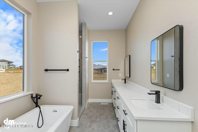 2600 S Sanctuary Dr, Wasilla, AK 99654 - bathroom with double vanity, a soaking tub, tile patterned flooring, a stall shower, and recessed lighting