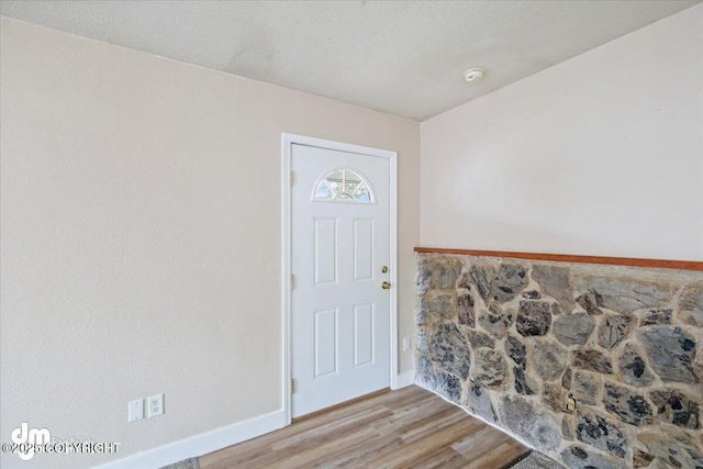 entrance foyer featuring baseboards and light wood-style flooring