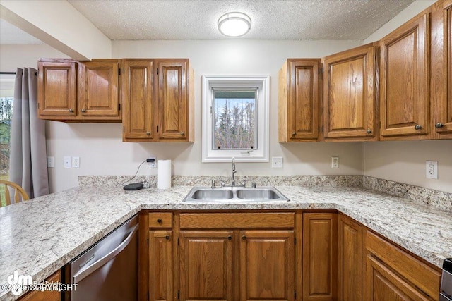 kitchen featuring brown cabinetry, a sink, dishwasher, and light countertops