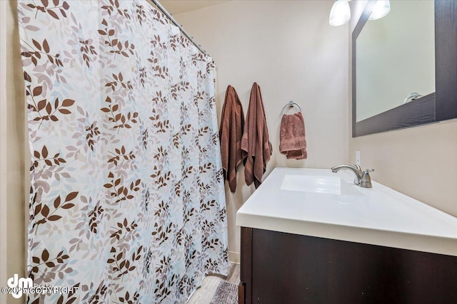 bathroom with vanity, a shower with curtain, and wood finished floors