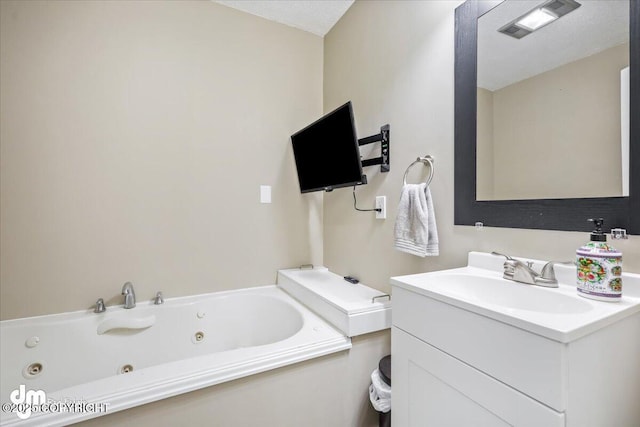 full bathroom featuring a jetted tub and vanity