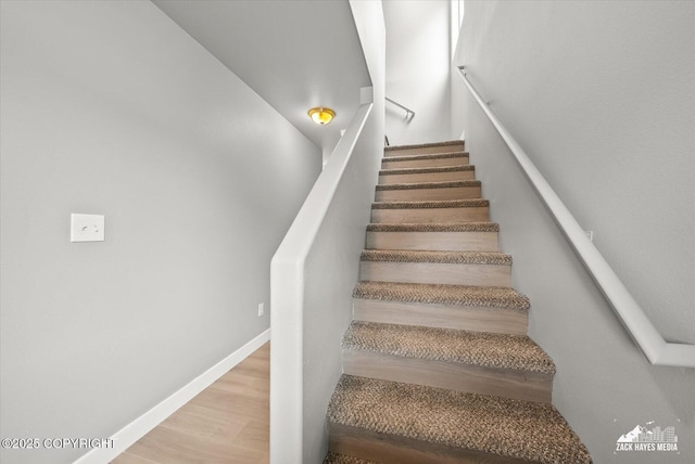 stairway featuring wood finished floors