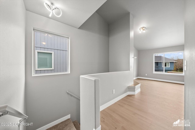 stairs with baseboards and wood finished floors