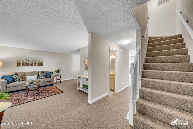 3294 Montpelier Ct # 12-E, Anchorage, AK 99503 - living area with stairway, light carpet, baseboards, and a textured ceiling
