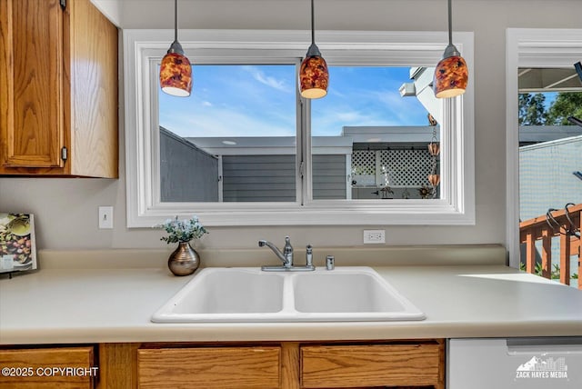 3294 Montpelier Ct # 12-E, Anchorage, AK 99503 - kitchen with a sink, dishwasher, hanging light fixtures, and light countertops