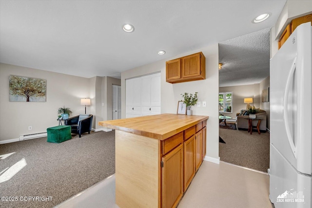 3294 Montpelier Ct # 12-E, Anchorage, AK 99503 - kitchen with freestanding refrigerator, open floor plan, light colored carpet, butcher block counters, and baseboards