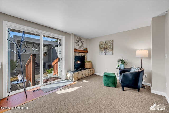 3294 Montpelier Ct # 12-E, Anchorage, AK 99503 - living area featuring a fireplace, baseboards, and carpet