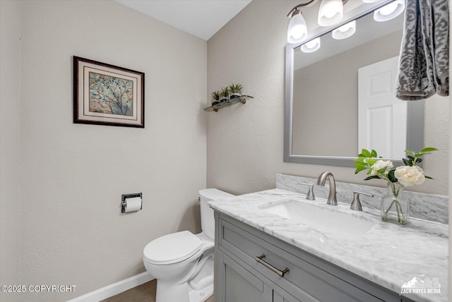 3294 Montpelier Ct # 12-E, Anchorage, AK 99503 - bathroom featuring vanity, toilet, baseboards, and wood finished floors