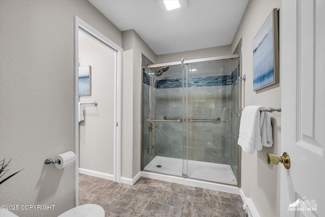 3294 Montpelier Ct # 12-E, Anchorage, AK 99503 - bathroom featuring a shower stall, baseboards, and toilet