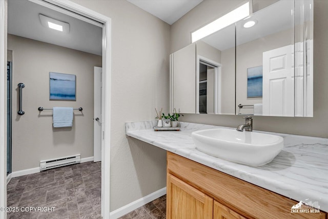 3294 Montpelier Ct # 12-E, Anchorage, AK 99503 - bathroom with a baseboard radiator, vanity, and baseboards
