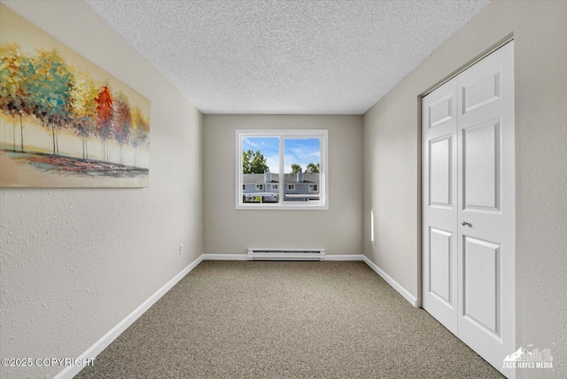 3294 Montpelier Ct # 12-E, Anchorage, AK 99503 - unfurnished bedroom with a baseboard radiator, carpet, a textured ceiling, baseboards, and a textured wall