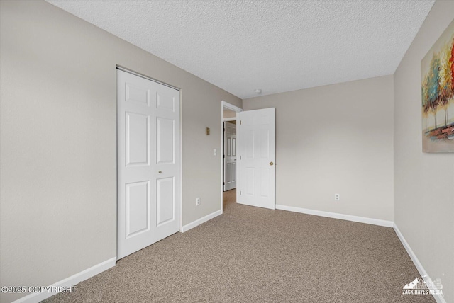 3294 Montpelier Ct # 12-E, Anchorage, AK 99503 - unfurnished bedroom featuring carpet floors, a textured ceiling, and baseboards