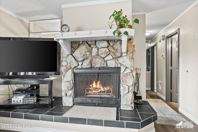 interior details featuring crown molding, wood finished floors, a fireplace, baseboards, and a textured ceiling