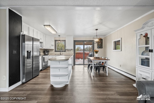 kitchen featuring open shelves, a sink, a baseboard heating unit, ornamental molding, and stainless steel appliances