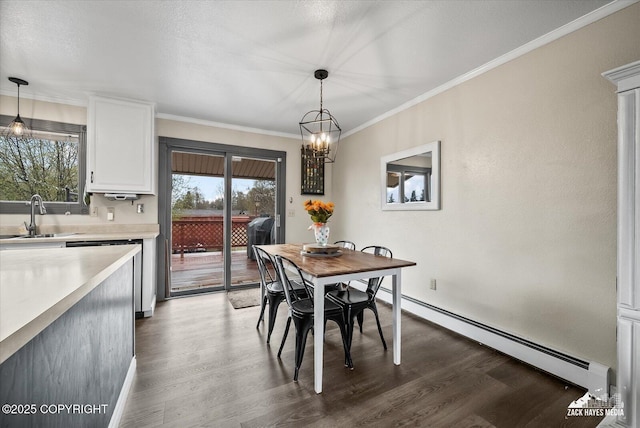dining room with a baseboard radiator, ornamental molding, wood finished floors, and a chandelier