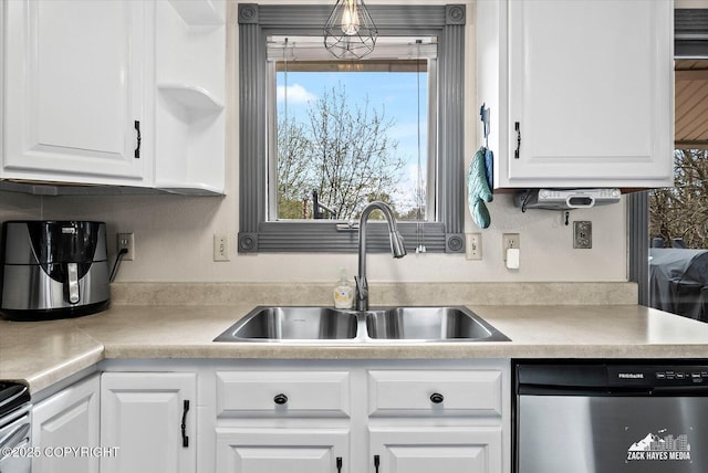 kitchen featuring a sink, light countertops, white cabinets, and dishwasher