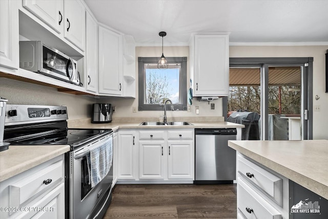 kitchen featuring dark wood-style floors, light countertops, white cabinets, a sink, and stainless steel appliances