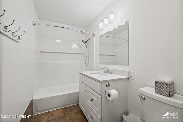 full bath with shower / bath combination, vanity, stone finish floor, and toilet