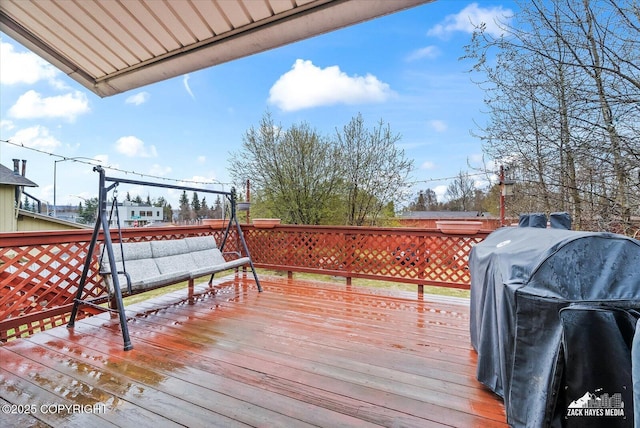 wooden terrace featuring grilling area