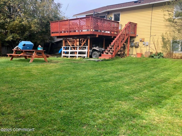rear view of house with a lawn, stairs, and a deck
